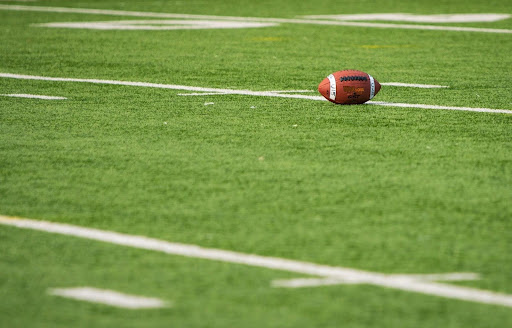 closeup-of-football-field-with-football-in-distance