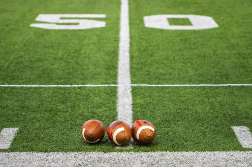 three-footballs-on-50-yard-line