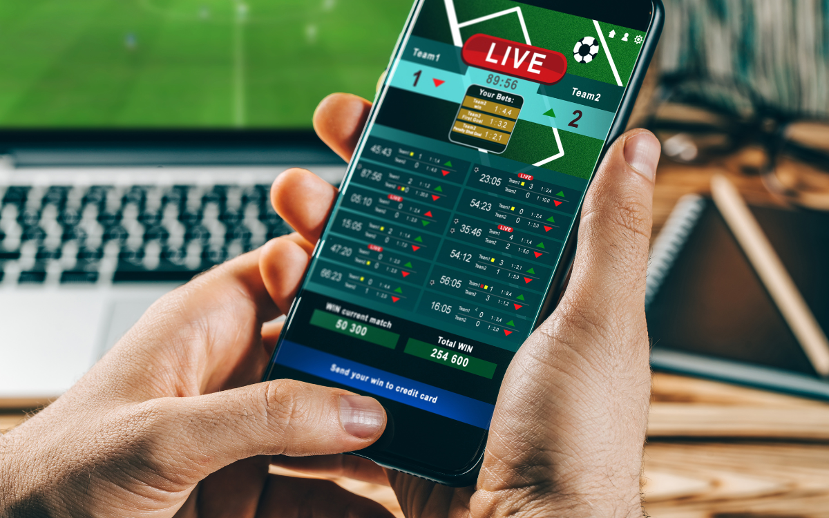 man-holding-phone-with-game-updates