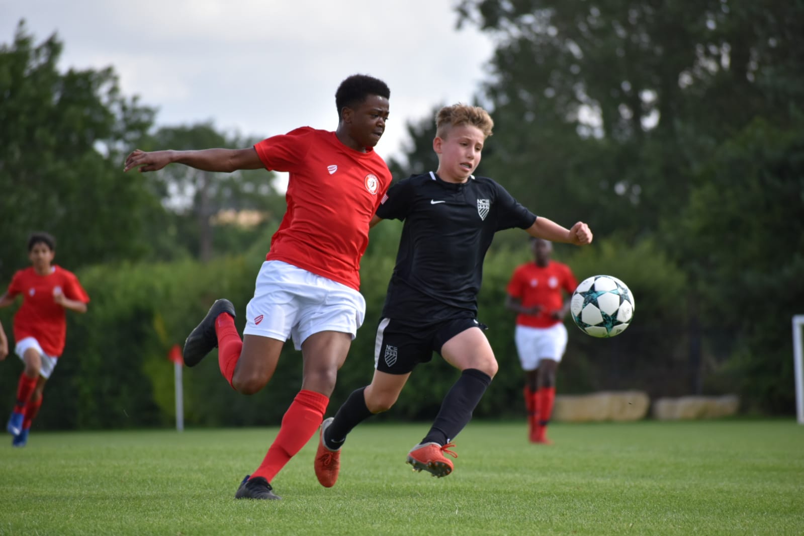 two-boys-running-towards-ball-soccer