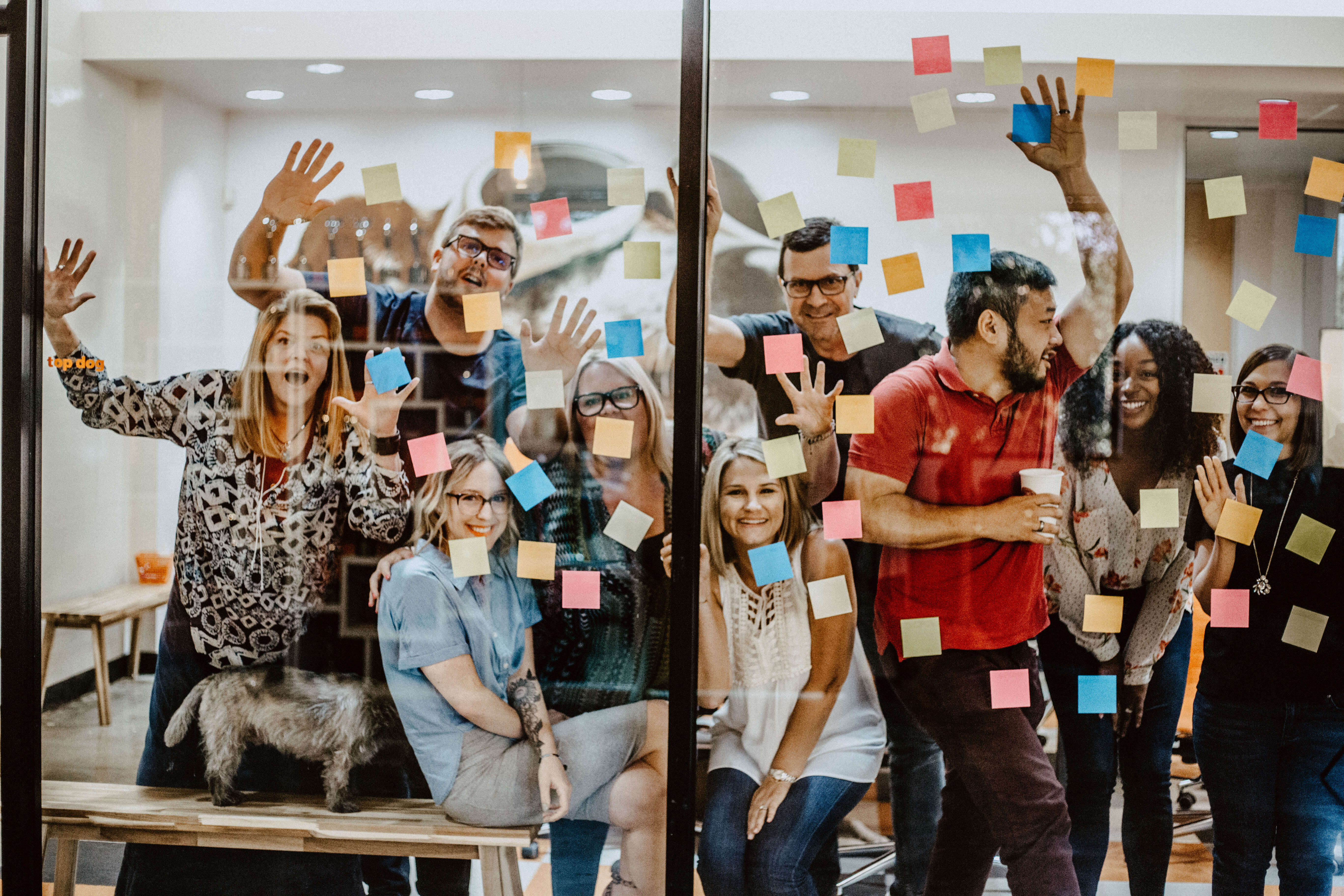crew-of-employees-standing-at-window-with-sticky-notes