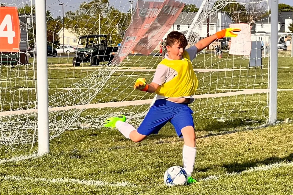 youth-sports-soccer-kid-goalie-kicking-ball
