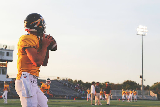 https://unsplash.com/photos/man-holding-brown-football-ball-m5pz9D6MfUk