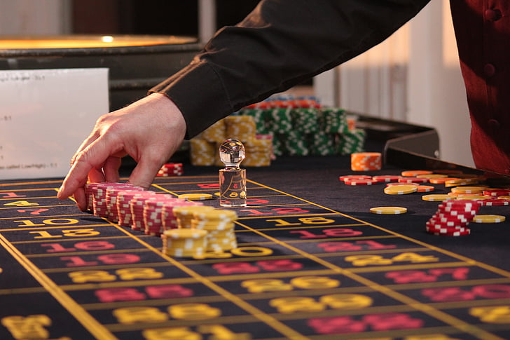 roulette-table-chips-casino-with-hand-on-board