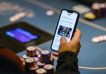 hand-holding-phone-displaying-gambling-game