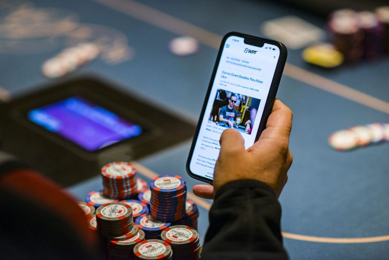 hand-holding-phone-displaying-gambling-game