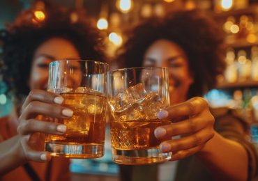 two-woman-clinking-drinks-together