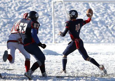 american-football-quarterback-passing-the-ball-on-a-snow-filled-field