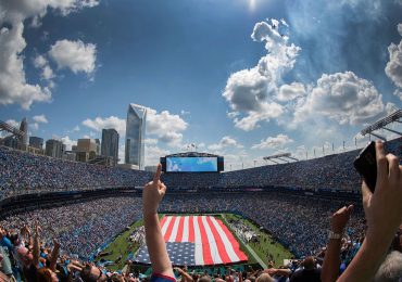 fans-cheering-in-stadium-with-American-flag-on-field