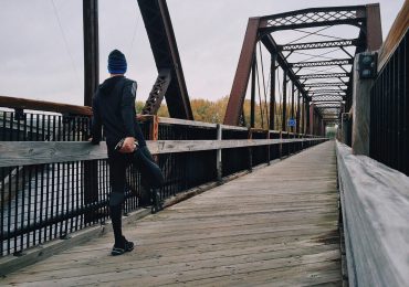 athlete-stretching-leg-during-run