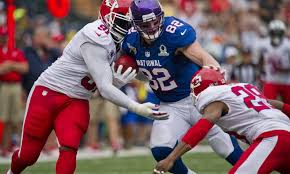 football-player-tackling-another