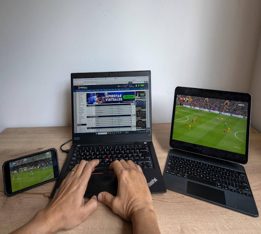 man-typing-at-computer-with-games-on