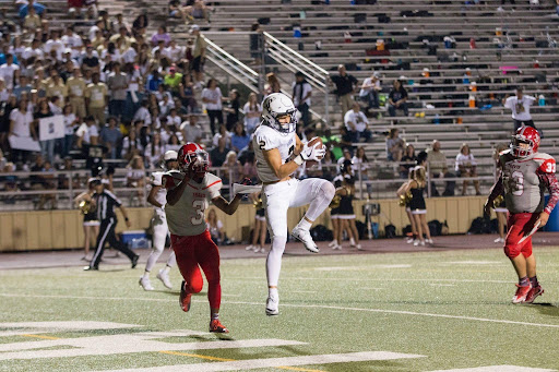 football-player-catching-ball-mid-jump